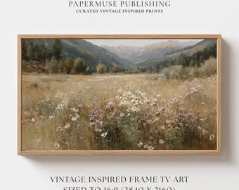May include: A framed landscape print featuring a field of wildflowers in shades of white and purple, with a mountain range in the background. The print is in a wooden frame and includes the text "PAPERMUSE PUBLISHING" and "VINTAGE INSPIRED FRAME TV ART".