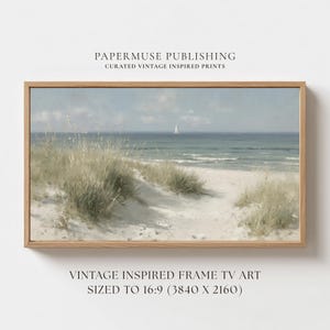 May include: A framed vintage-inspired print of a beach scene. The artwork features a sandy path leading to the ocean, with a sailboat on the horizon. The print includes text: "PAPERMUSE PUBLISHING CURATED VINTAGE INSPIRED PRINTS" and "VINTAGE INSPIRED FRAME TV ART SIZED TO 16:9 (3840 X 2160)".