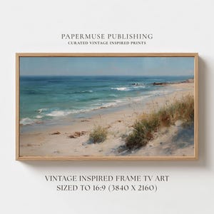 May include: A framed vintage-inspired print of a beach scene. The artwork depicts a sandy beach with turquoise water and a light blue sky. The frame is made of light-colored wood. The text "PAPERMUSE PUBLISHING" and "VINTAGE INSPIRED FRAME TV ART" are visible.