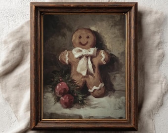May include: A framed vintage-style print depicting a gingerbread man with a white bow tie and icing details. Two red baubles and greenery are at the bottom. The frame is dark brown. The text "PAPERMUSE PUBLISHING" is at the bottom.