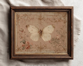 May include: A framed vintage print featuring a detailed illustration of a white butterfly with brown markings, centered on a pink background with floral and ornamental details. The dark brown frame surrounds the artwork. Text at the bottom reads "PAPERMUSE PUBLISHING".