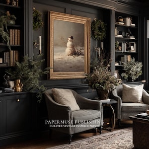 May include: A cozy living room scene with dark walls, bookshelves, and two armchairs. A framed vintage print of a snowman hangs above the chairs. The room is decorated with wreaths, greenery, and candles, creating a warm, inviting atmosphere. The text "PAPERMUSE PUBLISHING" is visible.