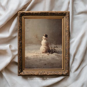 May include: A framed vintage print of a snowman in a snowy landscape. The snowman wears a top hat and has a carrot nose. The frame is ornate with a gold finish. The print is from PaperMuse Publishing.