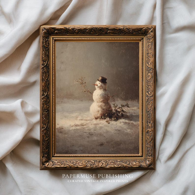 May include: A framed vintage print of a snowman in a snowy landscape. The snowman wears a top hat and has a carrot nose. The frame is ornate with a gold finish. The print is from PaperMuse Publishing.