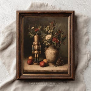May include: A framed vintage still life painting featuring a nutcracker, vase of flowers, apples, and a pinecone. The painting has a dark brown wooden frame and a muted color palette with a vintage aesthetic. The text "PAPERMUSE PUBLISHING" is visible.