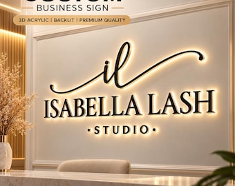 May include: A 3D acrylic backlit business sign mounted on a wall, featuring the text "il ISABELLA LASH STUDIO" in black lettering with a warm glowing light effect behind the characters, creating a halo illumination against the wall.