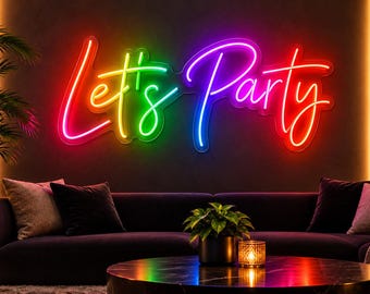 May include: A multi-colored neon sign mounted on a dark wall displaying the text Let's Party in a cursive script font. The sign features a gradient of red, orange, yellow, green, blue, and purple light, creating a vibrant glow above a sofa.
