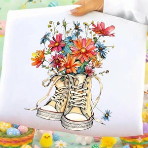 Könnte beinhalten: Ein Set aus drei Keramikbechern mit gesprenkelter, matter Oberfläche. Die Becher sind in Creme-, Hellgrau- und Dunkelgrautönen gehalten. Jeder Becher hat ein schlichtes, minimalistisches Design.