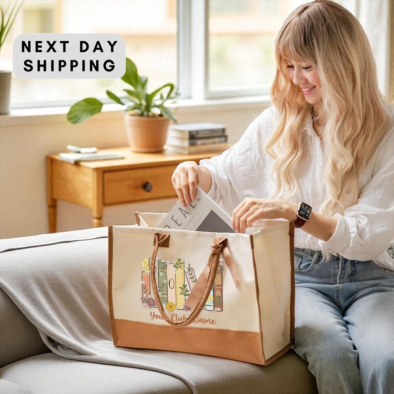 A woman with long blonde hair is sitting on a couch, holding a bag with a floral design and the text "Your Club Name" printed on it. She appears to be looking inside the bag, possibly searching for something.