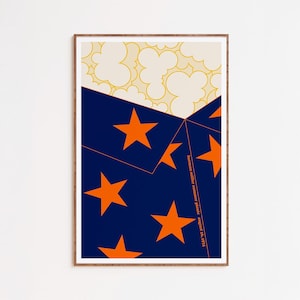 May include: A framed art print with an abstract design. The artwork features a navy blue section with orange stars, a cream section with yellow cloud shapes, and text in the lower right corner.