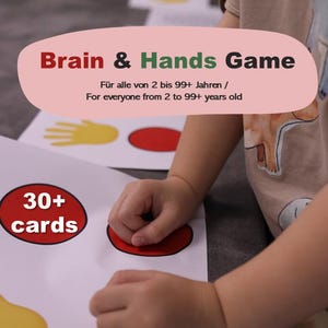 May include: A child's hands interacting with a game board featuring colorful shapes and the text "Brain & Hands Game." The game includes cards and is designed for ages 2 to 99+. The board has a red circle with "30+ cards" printed on it.