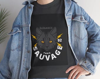 May include: Dark gray t-shirt featuring a black cat graphic with yellow eyes, lightning bolts, and the words "ÉLÉGANCE" and "SAUVAGE PARIS 92" in white. The shirt is made of a soft material.