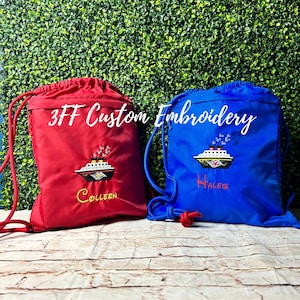 May include: Two red and blue drawstring bags with custom embroidery. The red bag has a white ship with the name "Colleen" embroidered on it. The blue bag has a white ship with the name "Wales" embroidered on it. Both bags have the text "3FF Custom Embroidery" on them.