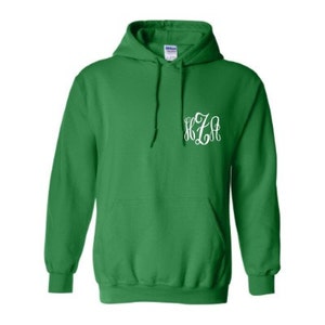 May include: A green hooded sweatshirt with a white monogram on the front. The monogram is "KZA".