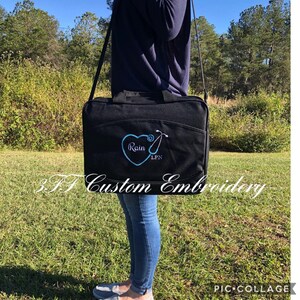 May include: Black canvas bag with a blue embroidered heart and stethoscope, the text "Rain LPN" is inside the heart.