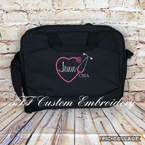 May include: Black laptop bag with a pink heart and a stethoscope embroidered on it. The heart has the name "Jenn" and the letters "CMA" embroidered inside it.