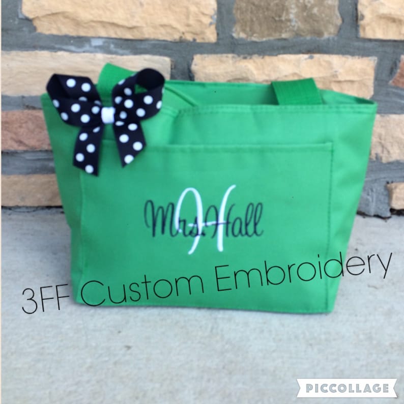 May include: Green tote bag with a white bow and black polka dots. The bag has a white embroidered name "Mrs. Hall" and the text "3FF Custom Embroidery".