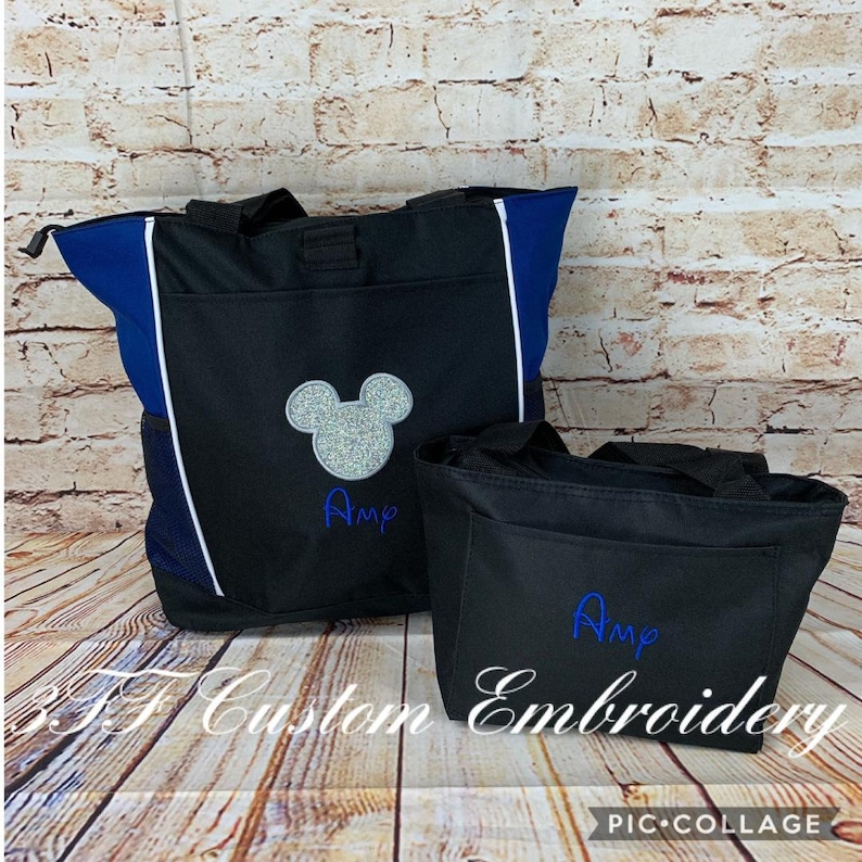 May include: Two black tote bags with blue accents. The larger bag has a silver glitter Mickey Mouse head and the name "Amy" embroidered in blue. The smaller bag has the name "Amy" embroidered in blue.