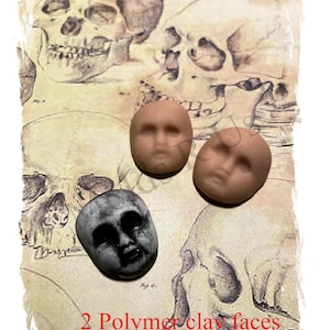 May include: Two polymer clay faces, one with a neutral expression and the other with a spooky, wide-eyed expression. The faces are displayed on a vintage anatomical drawing of skulls.