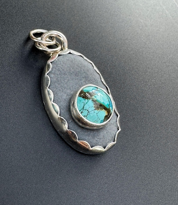 River stone with turquoise pendant