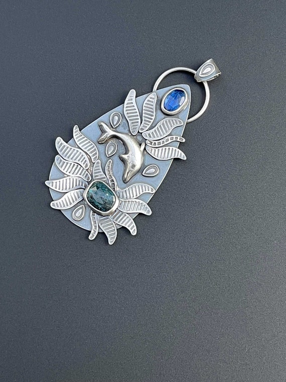 Silver dolphin pendant with blue and teal kyanite
