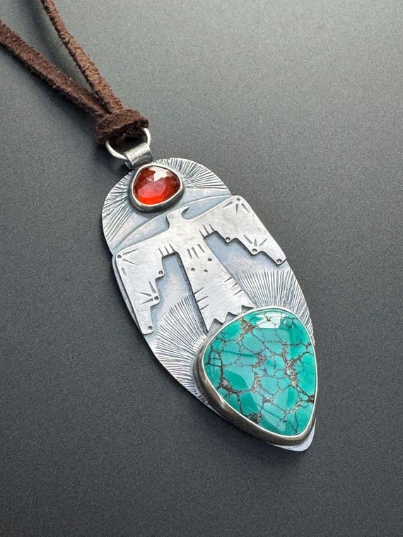 Thunderbird pendant with turquoise and garnet