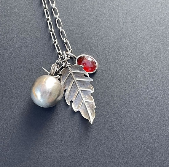 Hand fabricated cherry tomato, tomato leaf and garnet pendant