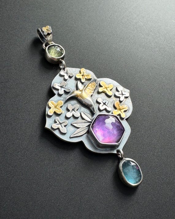 Hummingbird pendant with amethyst, kyanite and golden flowers