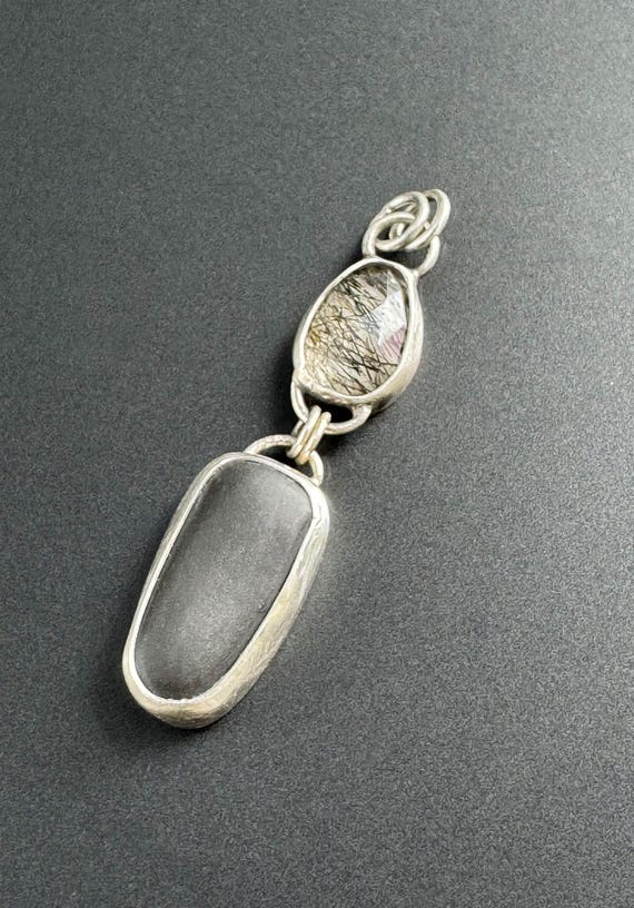 Beach stone pendant with Tourmalinated Quartz