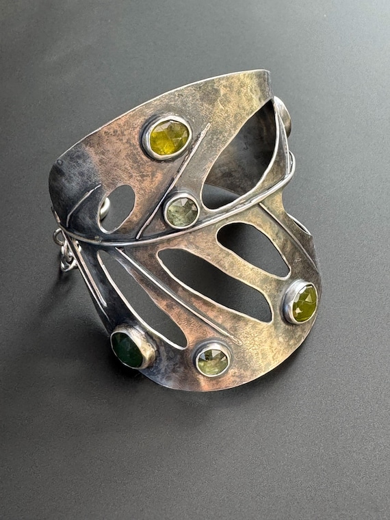 Hand forged monstera swiss cheese cuff with gemstones