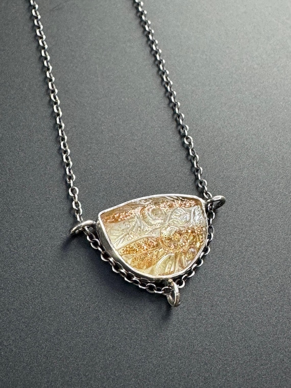Carved sunstone/quartz pendant