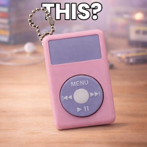 May include: A pink MP3 player keychain with a purple screen and control buttons. The text "REMEMBER THIS?" is above the player. The player has a silver chain attached.