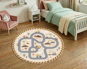 May include: A round beige rug with a construction site design. The rug features a road map with construction vehicles, trees, and road signs. The border has a yellow and black striped pattern.