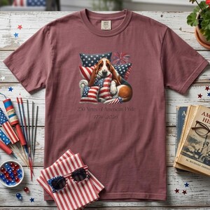 Basset hound 4th of July shirt in brick color with patriotic props sunglasses fireworks and American theme styling.