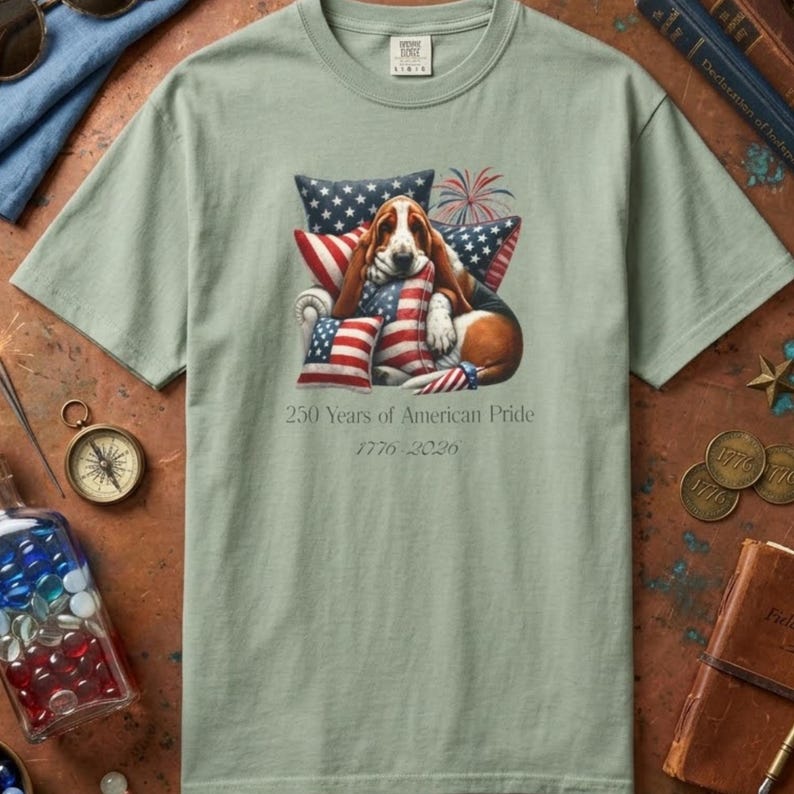 Basset hound USA shirt in bay green Comfort Colors tee with rustic patriotic decor compass coins and books.