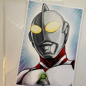 May include: A black and white illustration of a superhero with a red and white suit. The superhero has a large, silver head with a green gem on the chest. The background is a blue and white gradient.