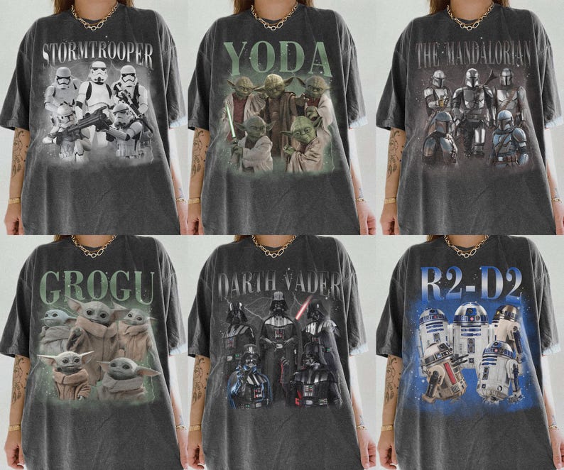 May include: Six dark gray t-shirts featuring Star Wars characters. The shirts display images of Stormtroopers, Yoda, The Mandalorian, Grogu, Darth Vader, and R2-D2. Each shirt has a unique graphic design and text related to the characters.
