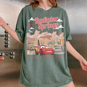 May include: A set of three ceramic mugs with a speckled, matte finish. The mugs are in shades of cream, light gray, and dark gray. Each mug has a simple, minimalist design and a rounded handle.