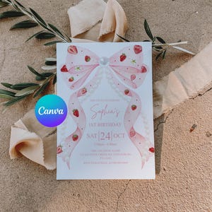 K&ouml;nnte beinhalten: Eine wei&szlig;e Einladungskarte mit einer rosa Schleife und Erdbeeren. Der Text lautet "Sophia's 1st Birthday" mit dem Datum "SAT 24 OCT". Das Canva-Logo ist zu sehen. Die Karte ist von Olivenzweigen und beigem Stoff umgeben.