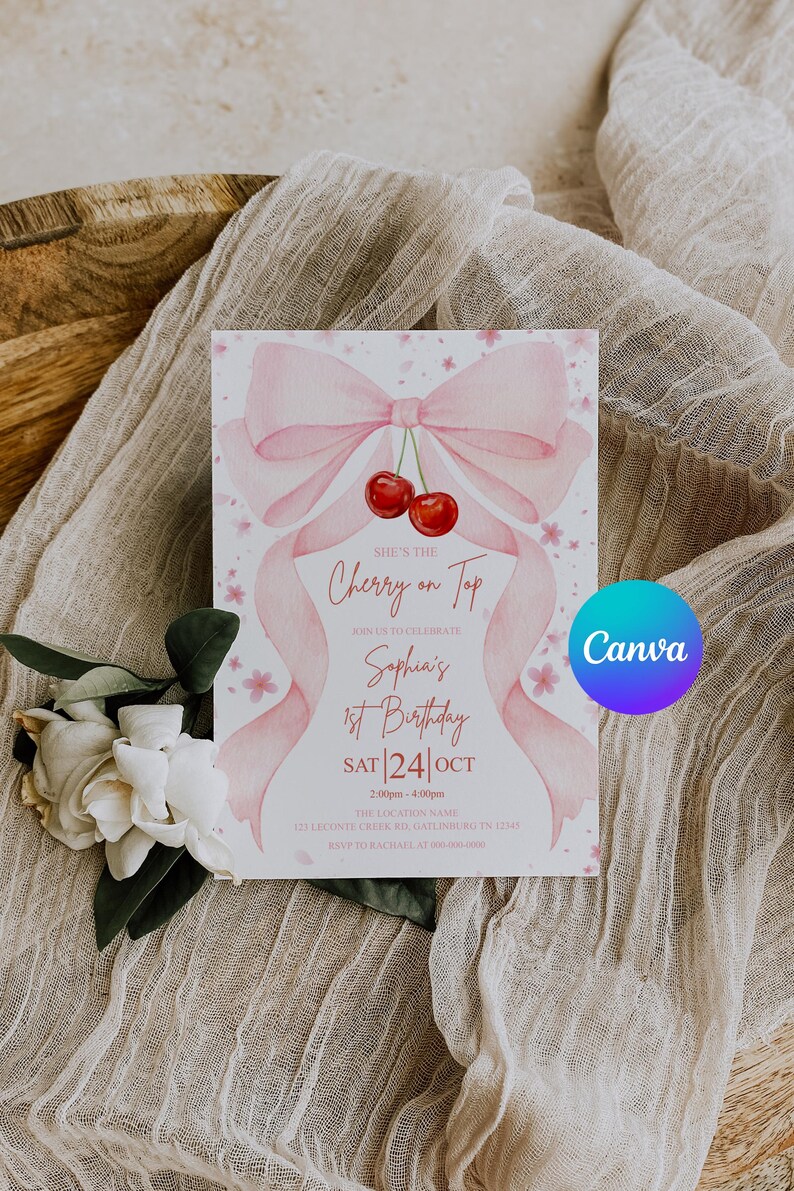 May include: A pink and white birthday invitation with a watercolor bow and cherries. The text reads "She's the Cherry on Top" and announces Sophia's 1st Birthday on October 24th. The Canva logo is visible.