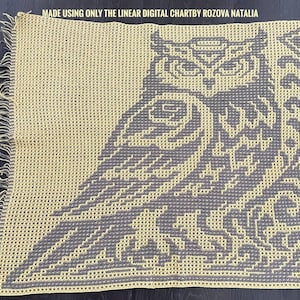 May include: A square crochet blanket featuring a two-tone owl design in grey and pale yellow. The text MADE USING ONLY THE LINEAR DIGITAL CHARTBY ROZOVA NATALIA is printed at the top. The blanket has a textured grid pattern and fringed edges.