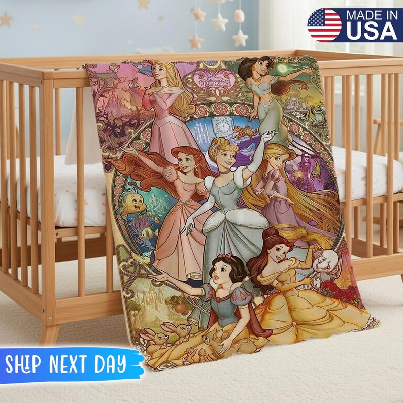 May include: A colorful blanket featuring various Disney princesses in a stained-glass style design. The blanket is draped over a wooden crib. The words "Made in USA" are visible in the upper right corner.