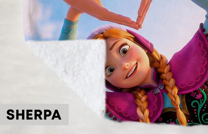 May include: Sherpa blanket featuring a smiling cartoon character with auburn braids, wearing a purple and pink outfit. The blanket has a white, fluffy texture. The word "SHERPA" is printed in bold, black letters.
