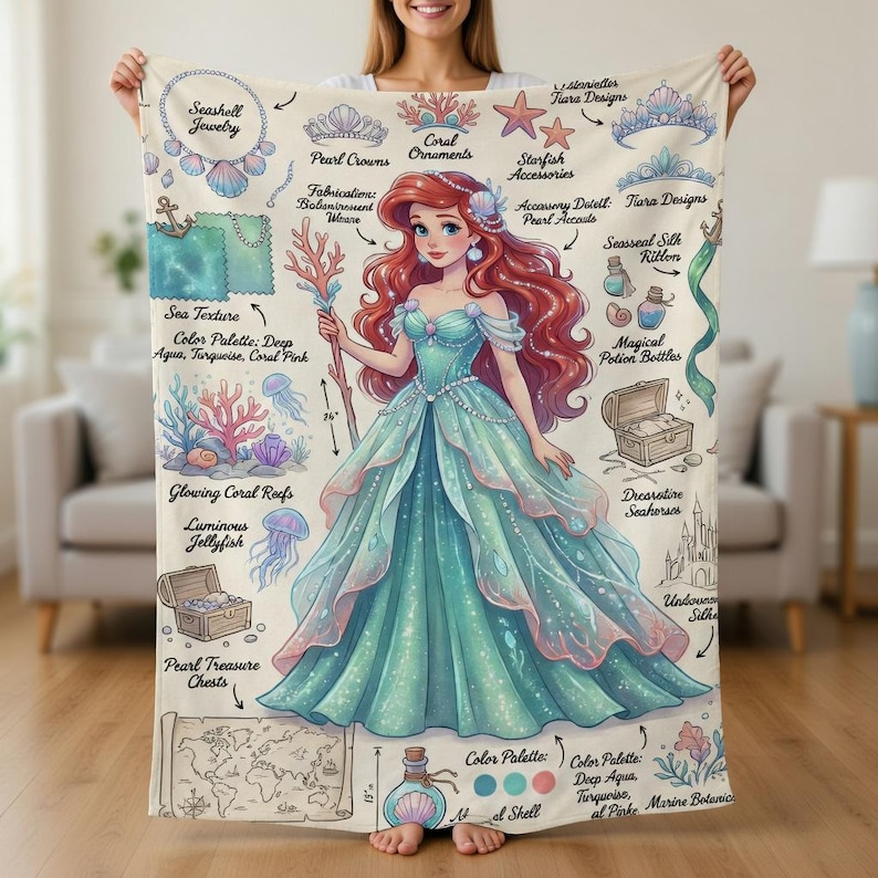 May include: A teal and pink blanket featuring an illustration of a mermaid with red hair and a teal gown. The blanket includes illustrations of seashells, coral, and other ocean-themed accessories. The color palette includes deep aqua, turquoise, and coral pink.