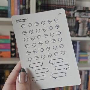 May include: A white sticker sheet featuring speech bubble designs. The sheet includes small speech bubbles with three dots and larger, empty speech bubbles. The text "speech bubble * by moonsigh" is printed on the sheet.