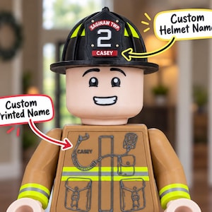 May include: A plastic firefighter minifigure wearing a black helmet with a yellow stripe and a red shield displaying the text SAGINAW TWP 2 CASEY. The tan torso features a printed radio, pockets, reflective stripes, and the name CASEY.