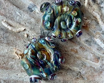 Deep green shiny metallic ammonite lampwork bead pair