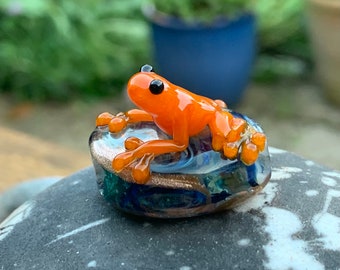 Orange frog on lampwork glass focal bead. Would work as a mini ornament, or as the centrepiece of a necklace