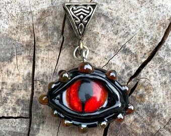 Red lampwork glass dragon eye pendant with textured silver plated bail