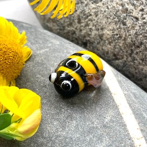 Cute lampwoork glass bee bead. Available as a single bead, bead pair or as a pendant or pair of earrings with sterling silver findings